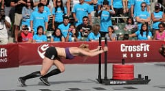 Picture of Annie Thorisdottir performing the sled push at CrossFit Games https://get-strong.fit